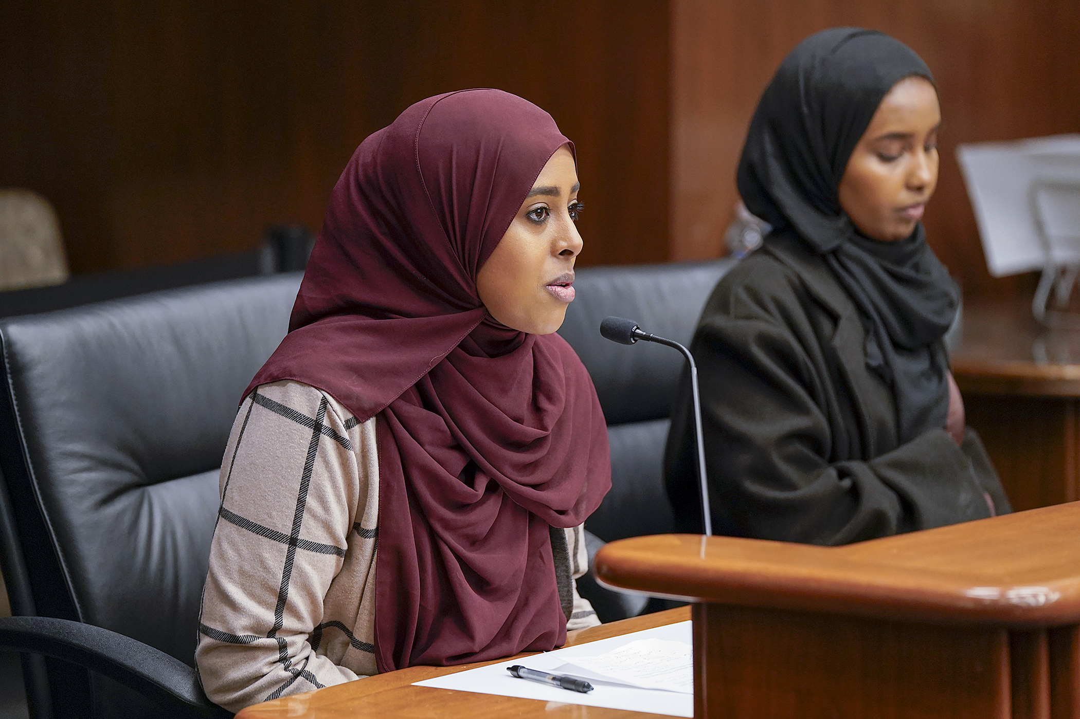 Nadira Mohamed, left, testifies before the House Workforce Development Finance and Policy Committee April 3 in support of HF5065 to provide funding for the Minnesota STEM Project and the Milestone Tech Program. Kawthar Mohamud also testified. (Photo by Michele Jokinen)